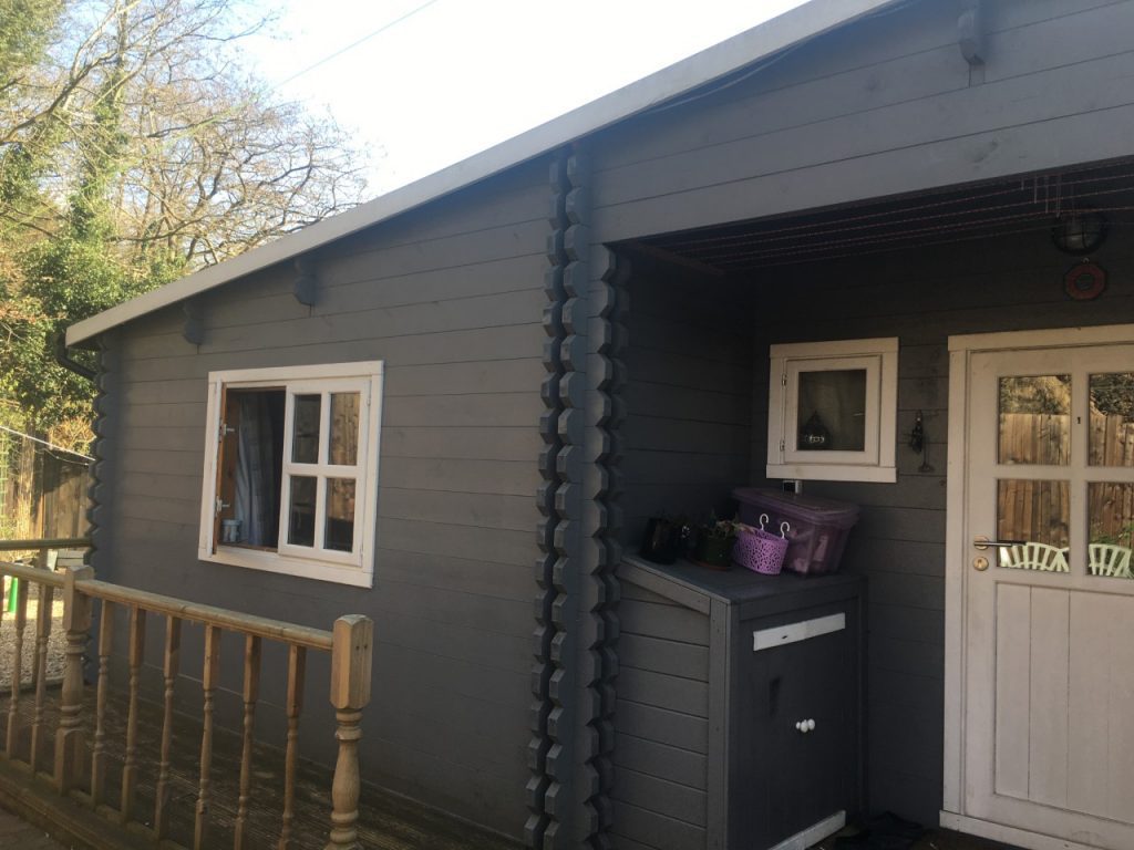 A barn converted into a house, it has been recently painted dark grey