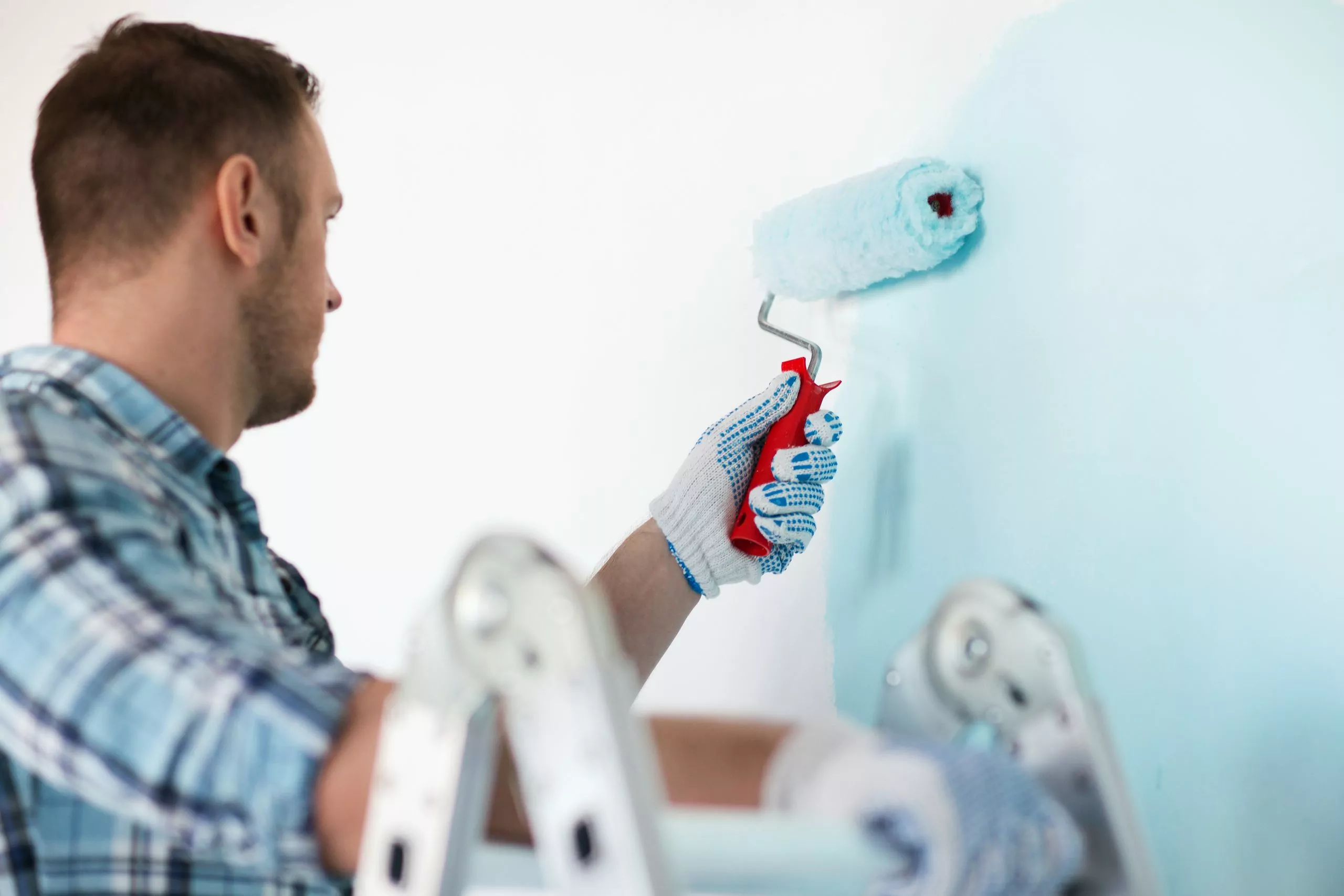 Man painting over distemper paint