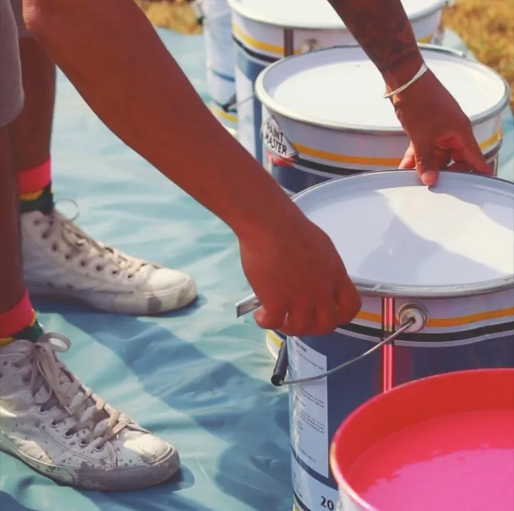 open multi coloured paint tins