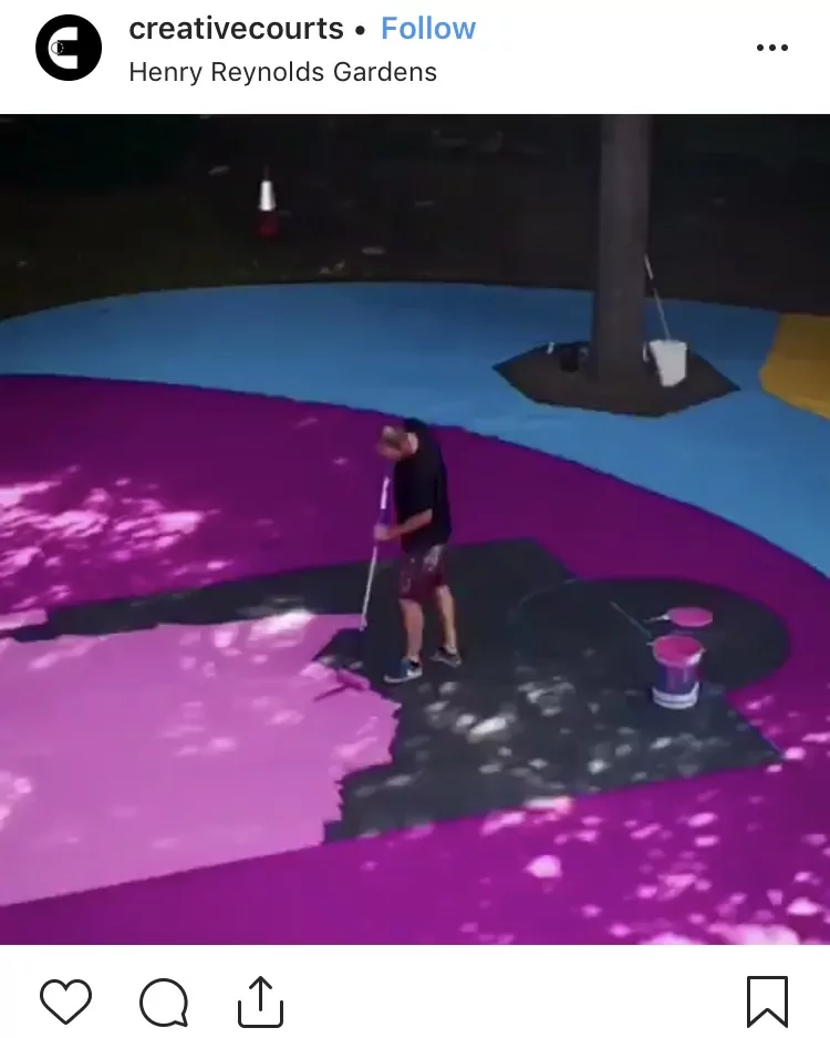 Rolling new paint on outdoor basketball court black